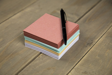 note on wood background with pen
