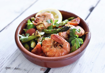 Fresh jumbo shrimps and green asparagus, delicious dish or meal, close-up shot. Spanish Tapas.