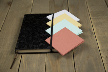 Fototapeta premium notepad with sticker on wood background