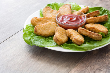 Fried chicken nuggets on wooden table
