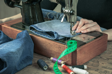 Sewing supplies and clothes with an old sewing machine.