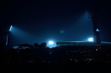 Stadium floodlights against a dark night