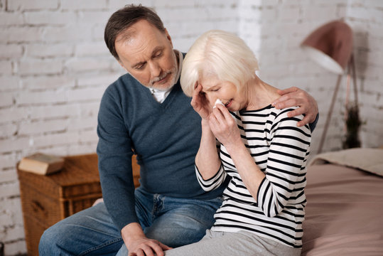 Elderly Man Giving Solace To His Sad Wife