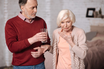 Aged woman feeling bad near her husband