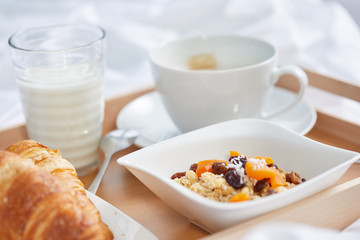 breakfast in bed with coffee and croissants