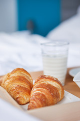 breakfast in bed with coffee and croissants