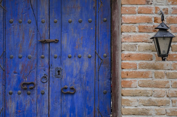Detail of an old door and lantern on street