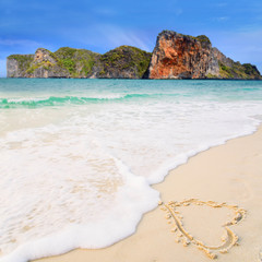 Heart drawn in the sand. Beach background. Top view