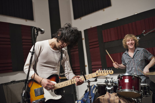 Musicians rehearsing at recording studio