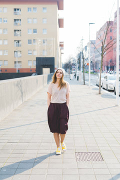 Young beautiful woman posing outdoor in the city - getting away from it all, city living, everyday life concept