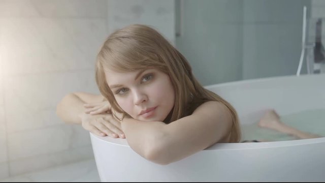 beautiful women relaxing in bathtub filled with hot water