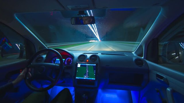 The man drive a car in the evening highway. Inside view. Hyperlapse. Wide angle