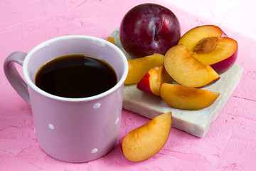 A сup of coffee and plums