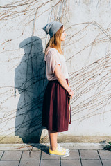 Sideview of young beautiful woman posing outdoor in the city - getting away from it all, city...