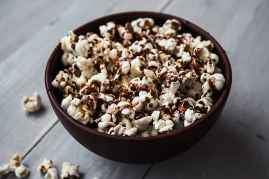 bowl with chocolate popcorn on wood