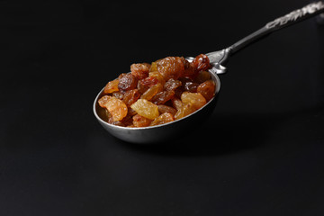 raisins  in steel spoon