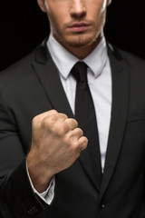Professional special agent in a suit posing on black background