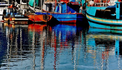 Fototapeta na wymiar Colorful Fishing boats in small harbour