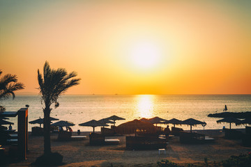 Sun over Hotel beach and sea