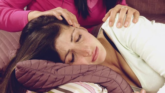 Sad woman crying in bed feeling betrayed  comforted by girlfriend