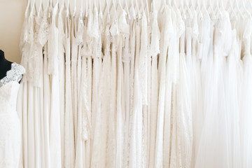 Many wedding dresses in atelier. Background