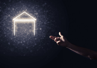 Conceptual image with hand pointing at house or main page icon o