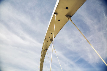 Bridge structure in blue cloudy sky