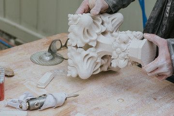 restorer fixes piece of white marble statue