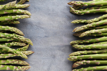 Green asparagus on grey wooden table
