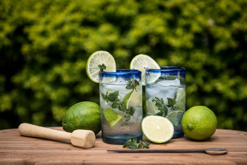 Two mojito drinks with lime and mint