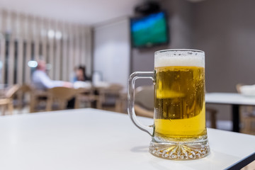 glass of beer in the cafeteria closeup