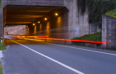 Car on the road passing through a tunnel..