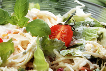 bowl of salad with vegetables and greens on wooden table