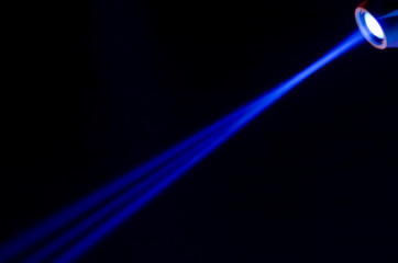 Beam of blue light on black background. Applied to a searchlight, torch.