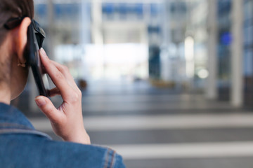 Woman talking on smartphone, back view, with space for text or design concepts.