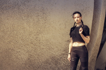Portrait of a gothic teenage girl on a background of gothic architecture