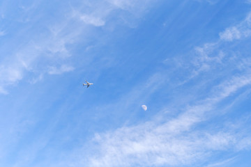 Aircraft. The moon, the blue sky, white clouds
