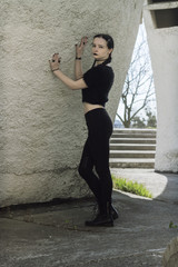 Portrait of a gothic teenage girl on a background of gothic architecture