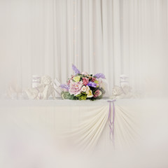 holiday wedding table in white and violet tones with compositions of flowers