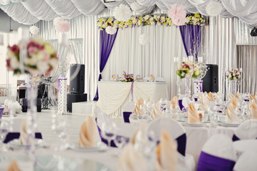 holiday wedding table in white and violet tones with compositions of flowers