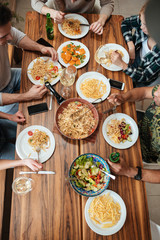 Top view of people having dinner together while sitting