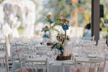 Wedding table decoration with candles and rose bouquets