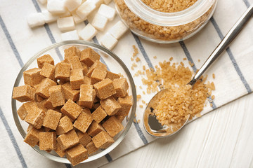 Bowl and spoon with brown sugar on napkin
