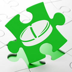 Health concept: Pill on puzzle background