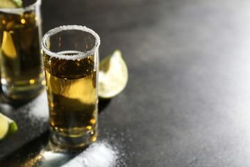 Tequila shot with salt on table, closeup