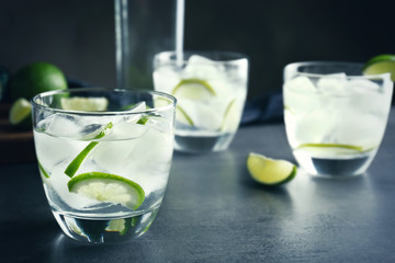 Alcohol cocktail with lime on table