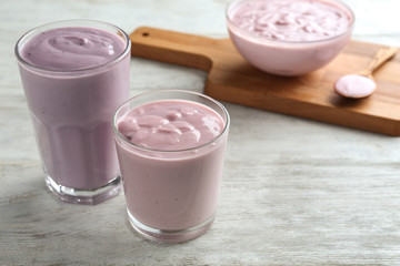 Glasses of homemade yogurt on wooden background