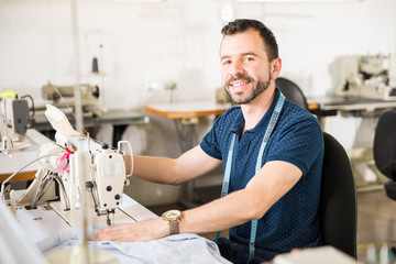 Male tailor sewing some clothes