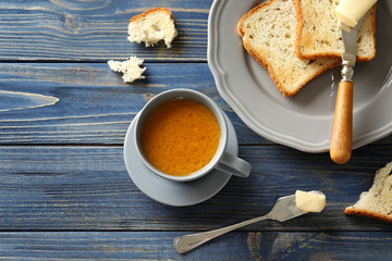 Composition with tasty butter coffee and toasts on wooden table