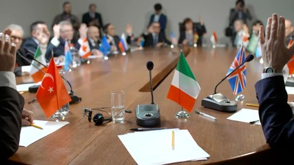 Participants of international economic conference or summit from Group of Great Twenty take their seats at the round table. Italian delegate's speech. Audience vote for the new law about refugees.